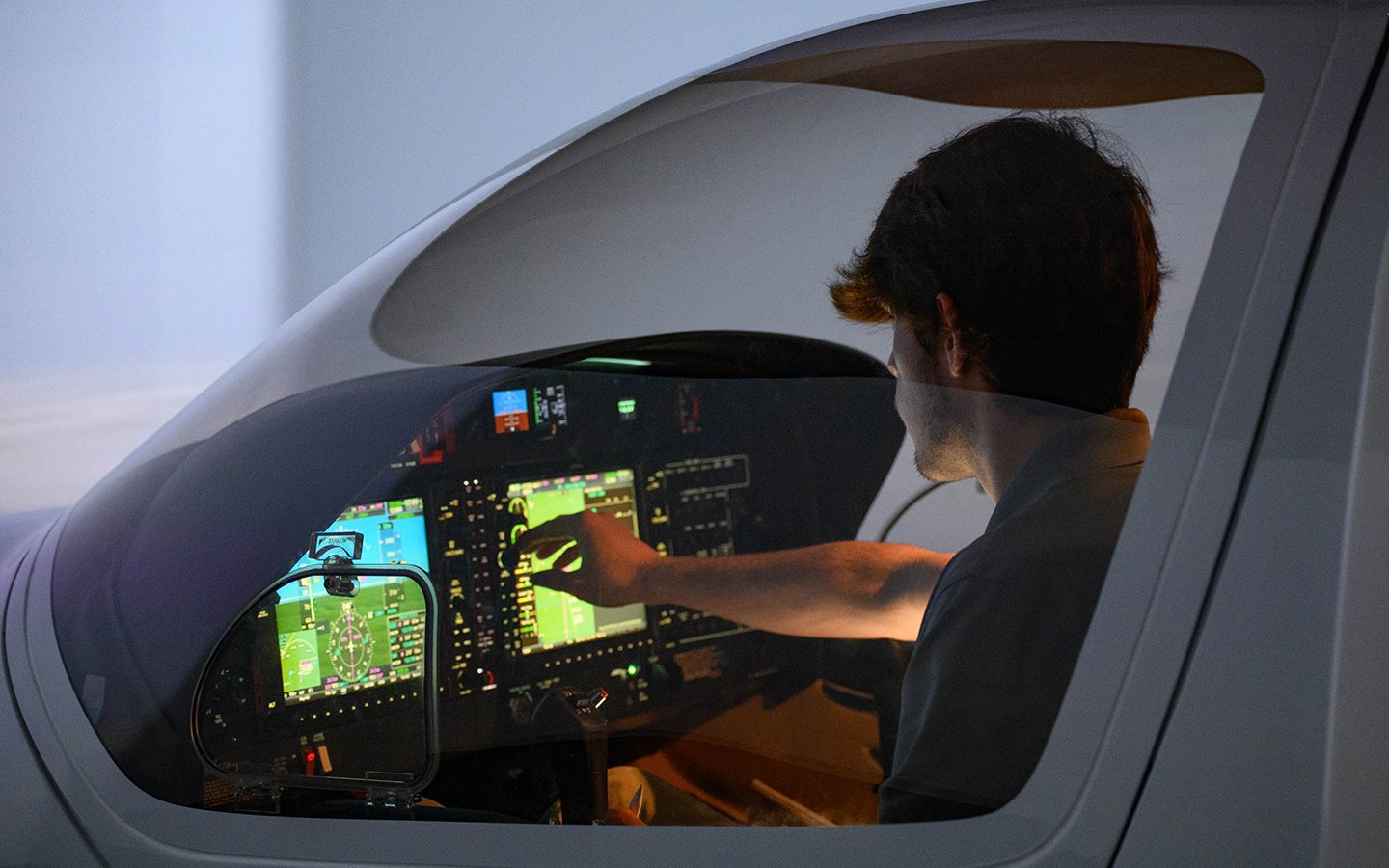 Diamond flight Simulator at the North Carolina location with student adjusting touchscreen controls