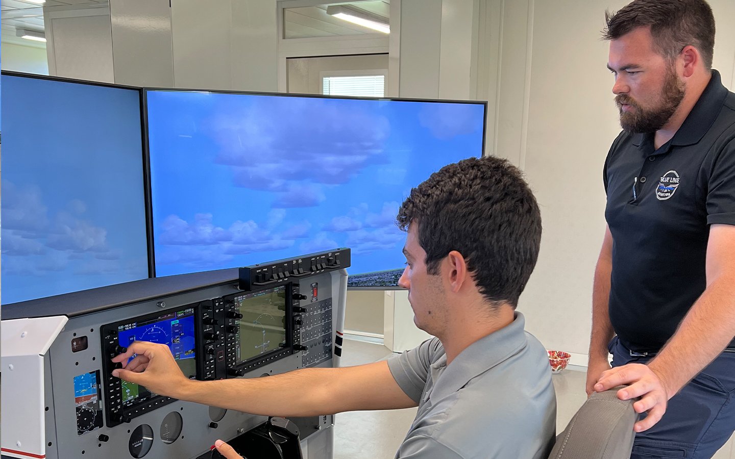 A student adjusts controls on the FRASCA flight simulator at our Florida location.